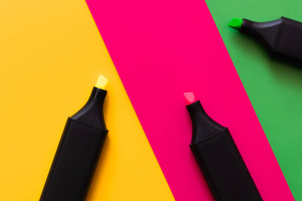 top view of marker pens on multicolored background 
