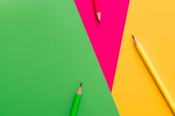 top view of pencils on multicolored background 