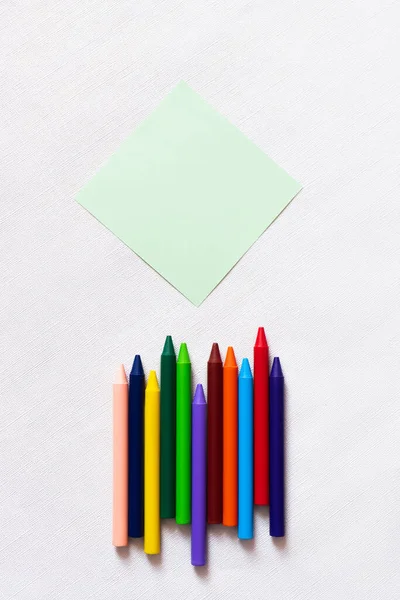 Top View Colorful Crayons Empty Paper Note Textured White Background — 스톡 사진