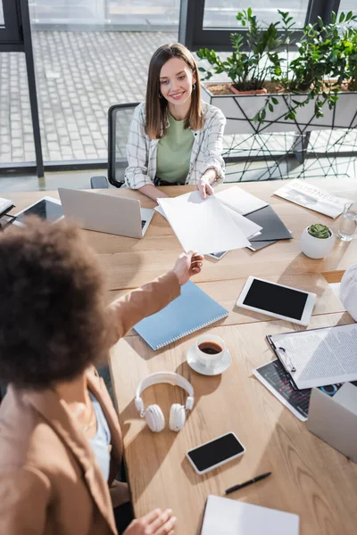 Overhead View Smiling Businesswoman Giving Papers African American Colleague Devices — Stock Fotó