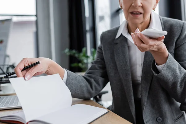 Cropped View Businesswoman Sending Voice Message Blank Notebook — Stock Fotó