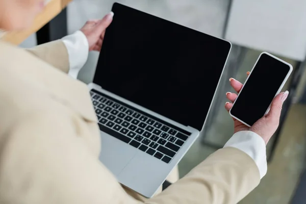 Cropped View Banker Holding Mobile Phone Laptop Blank Screen Office — Stockfoto