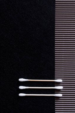 top view of two cotton ear sticks on black and textured background with copy space clipart