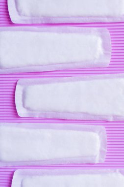 top view of soft breathable panty liners on textured violet background
