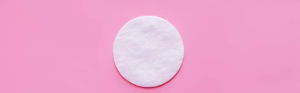 top view of cosmetic cotton pad on pink background, banner