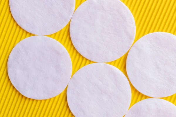 Close White Cotton Pads Yellow Textured Background Top View — Stock Photo, Image