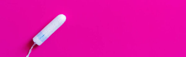 top view of tampon on bright purple background with copy space, banner
