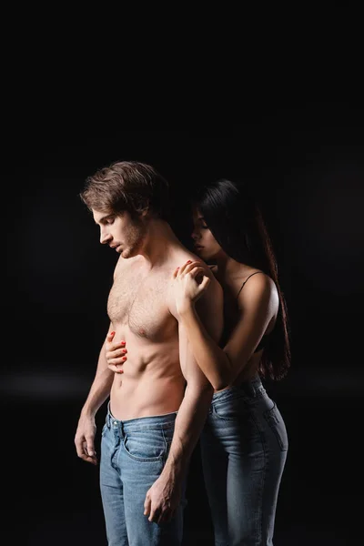 Seductive Woman Jeans Hugging Muscular Man Black Background — Stock fotografie