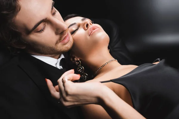Seductive Woman Dress Touching Boyfriend Suit Black Background — Stockfoto