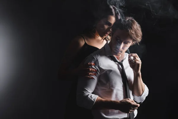 Sexy Woman Hugging Boyfriend Cigarette Black Background — Stockfoto