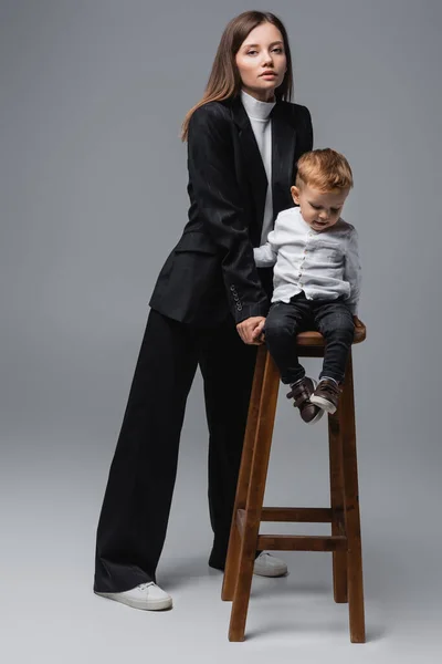 Full Length View Woman Black Suit Standing Son High Stool — Foto Stock