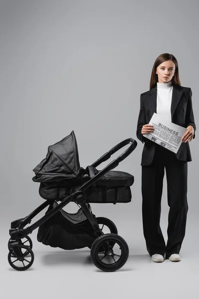 Woman Black Suit Standing Business Newspaper Baby Carriage Grey — Stock fotografie