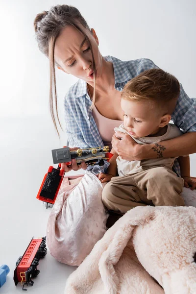 Excited Woman Hugging Son While Holding Toy Train White — Foto de Stock