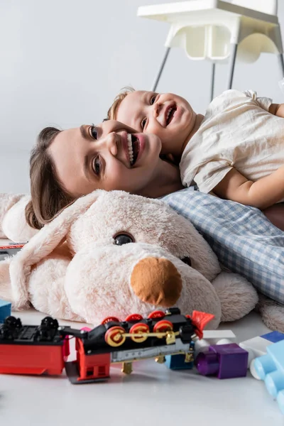 Laughing Woman Looking Camera Son Huge Soft Toy Grey — Foto Stock