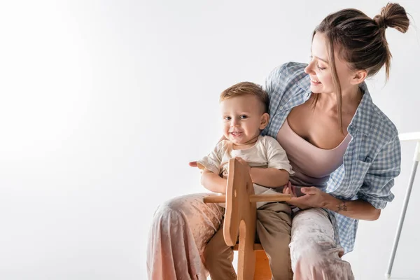 Happy Boy Sitting Rocking Horse Young Mother White —  Fotos de Stock