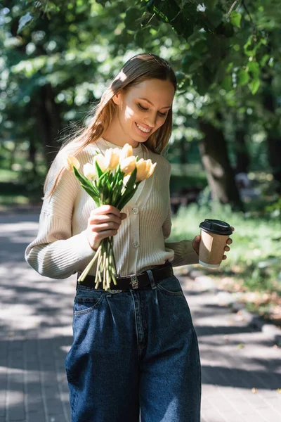 Happy Woman Blue Denim Jeans Walking Bouquet Tulips Paper Cup — Fotografia de Stock