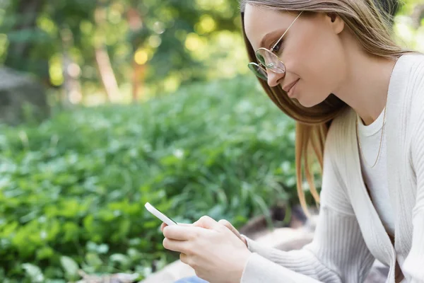 Side View Woman Glasses Messaging Smartphone Green Park — Fotografie, imagine de stoc