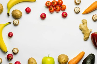 Top view of frame from ripe fruits and vegetables on white background 