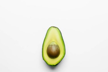 Top view of cut avocado on white background