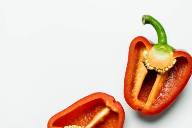 Top view of cut ripe paprika on white background with copy space 