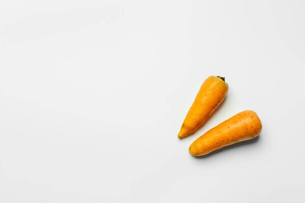 Top view of ripe carrots on white background 