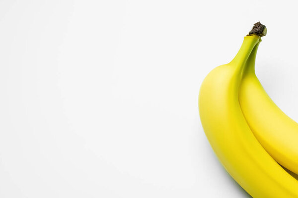 Top view of yellow bananas on white background with copy space 