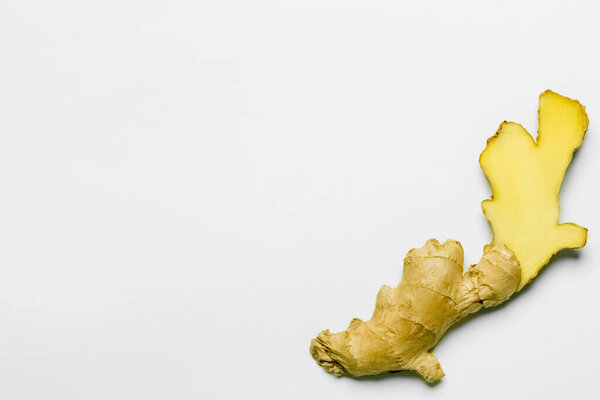 Top view of cut ginger on white background