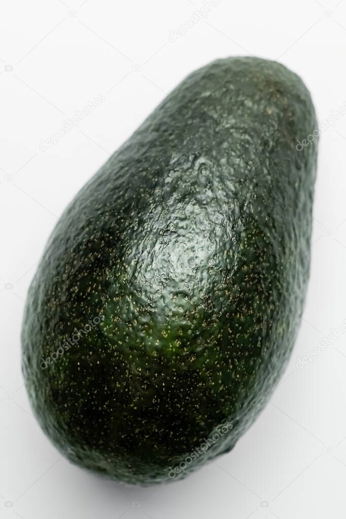 Close up view of green avocado on white background 