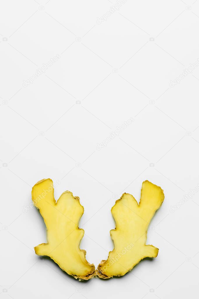Top view of organic cut ginger on white background