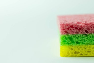 close up view of colorful porous sponge cloths on grey background