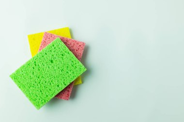 top view of cellulose sponge cloths on grey background