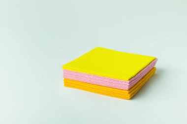 soft multicolored cleansing napkins stacked on grey background
