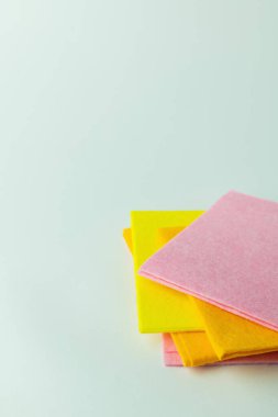 bright multicolored fabric napkins on grey background with copy space