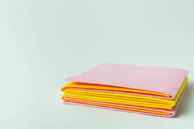 pink, yellow and orange cleansing napkins on grey background