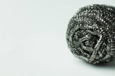 close up view of metal wire scourer on grey background with copy space clipart