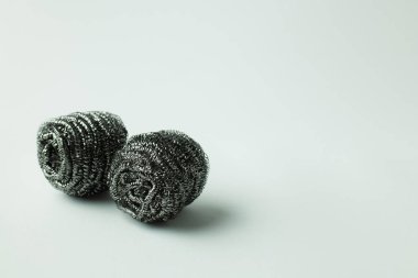 abrasive steel scourers on grey background with copy space clipart