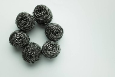 top view of circle made of stainless steel scourers on grey background clipart