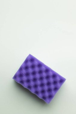 top view of bright purple sponge on grey background