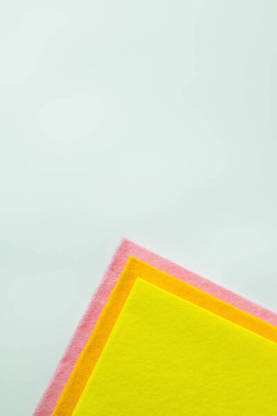 top view of bright and multicolored dishrags isolated on grey with copy space
