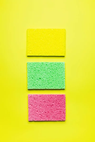 Top View Bright Multicolored Sponge Cloths Yellow Background — стоковое фото