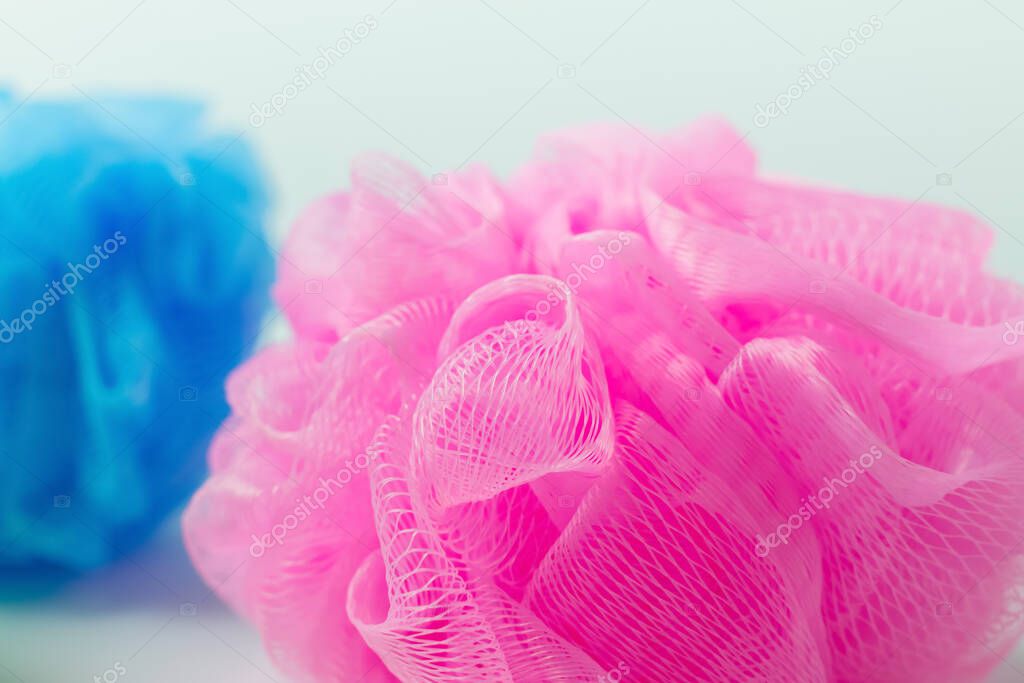 close up view of pink and blue washcloths on grey background