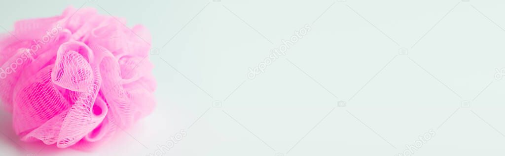 top view of pink shower puff on grey background with copy space, banner
