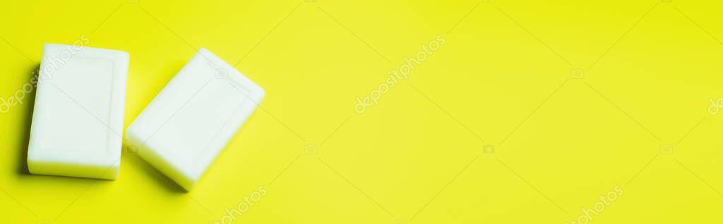 top view of cleansing toilet soap on yellow background with copy space, banner