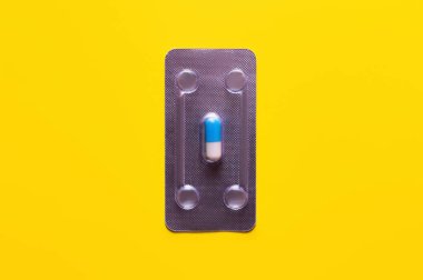 top view of blister pack with capsule isolated on yellow