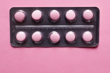 top view of blister pack with pills isolated on pink