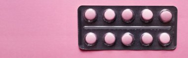 top view of blister pack with pills isolated on pink, banner
