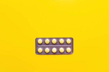 top view of blister pack with medication isolated on yellow clipart