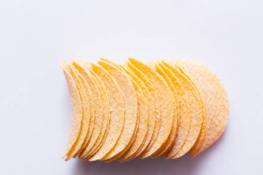 top view of salty and crunchy potato chips on white