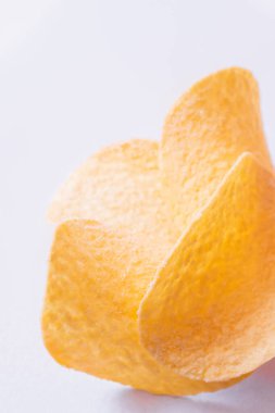 close up of fried potato chips on white background 