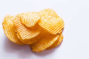 close up view of wavy and salty potato chips on white clipart